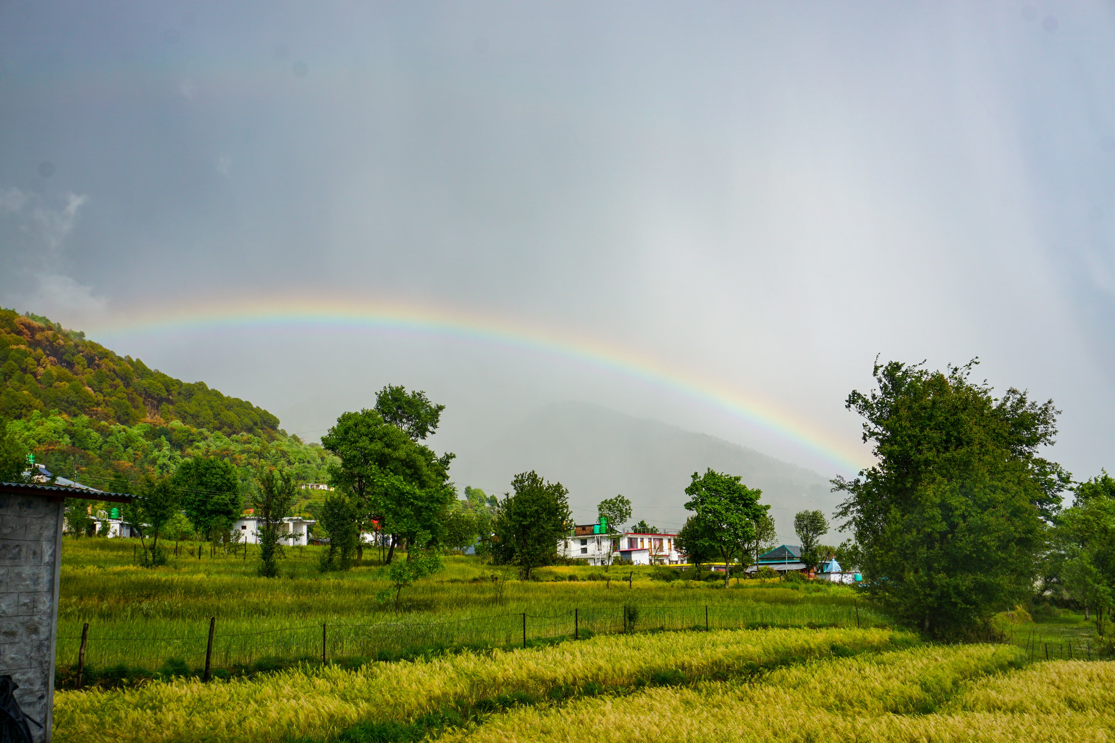 Double rainbow over mountains with fog
