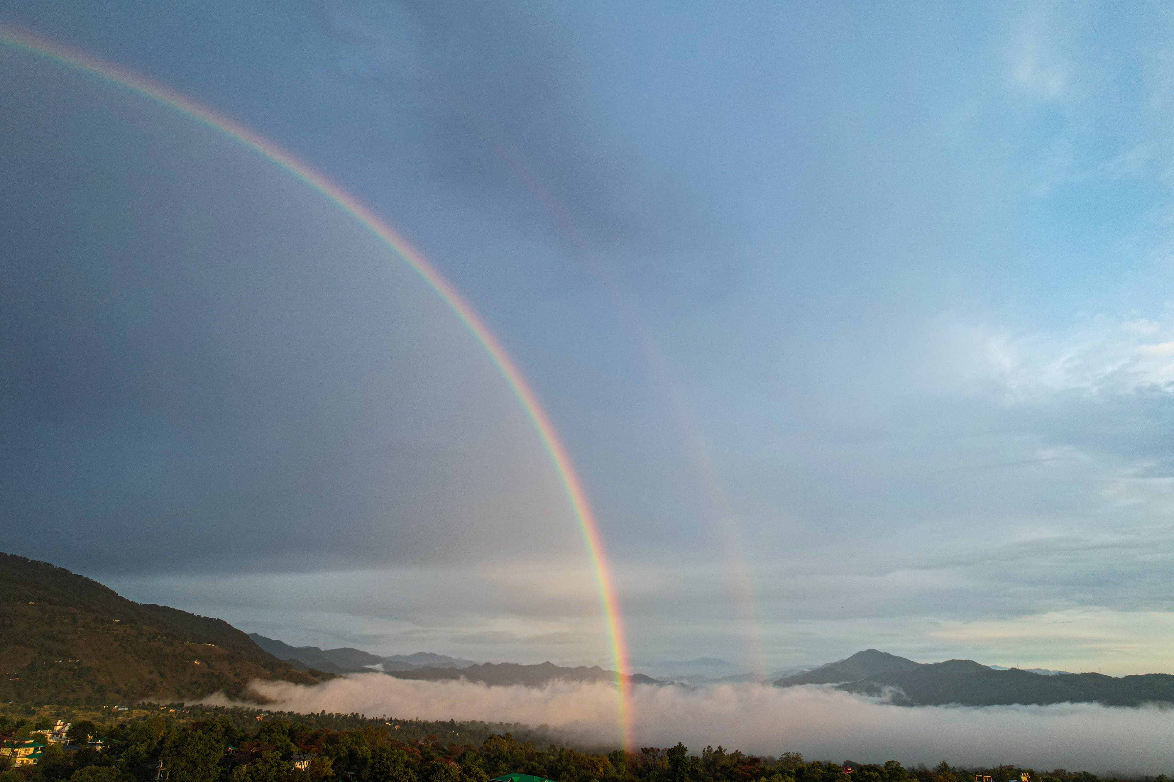 Aerial view of mountainous valley at sunset with rural settlement
