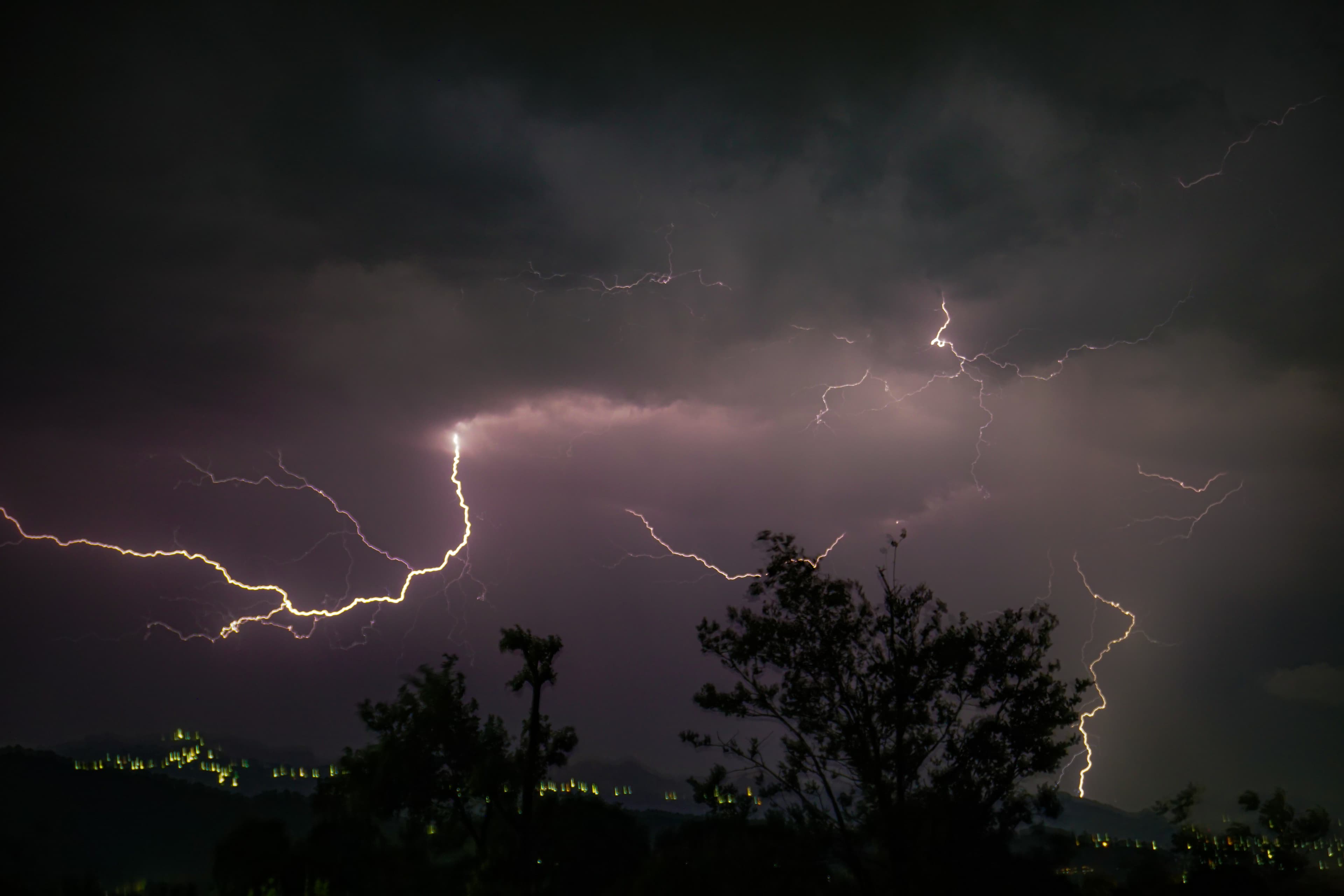 Lightning storm over mountains at night