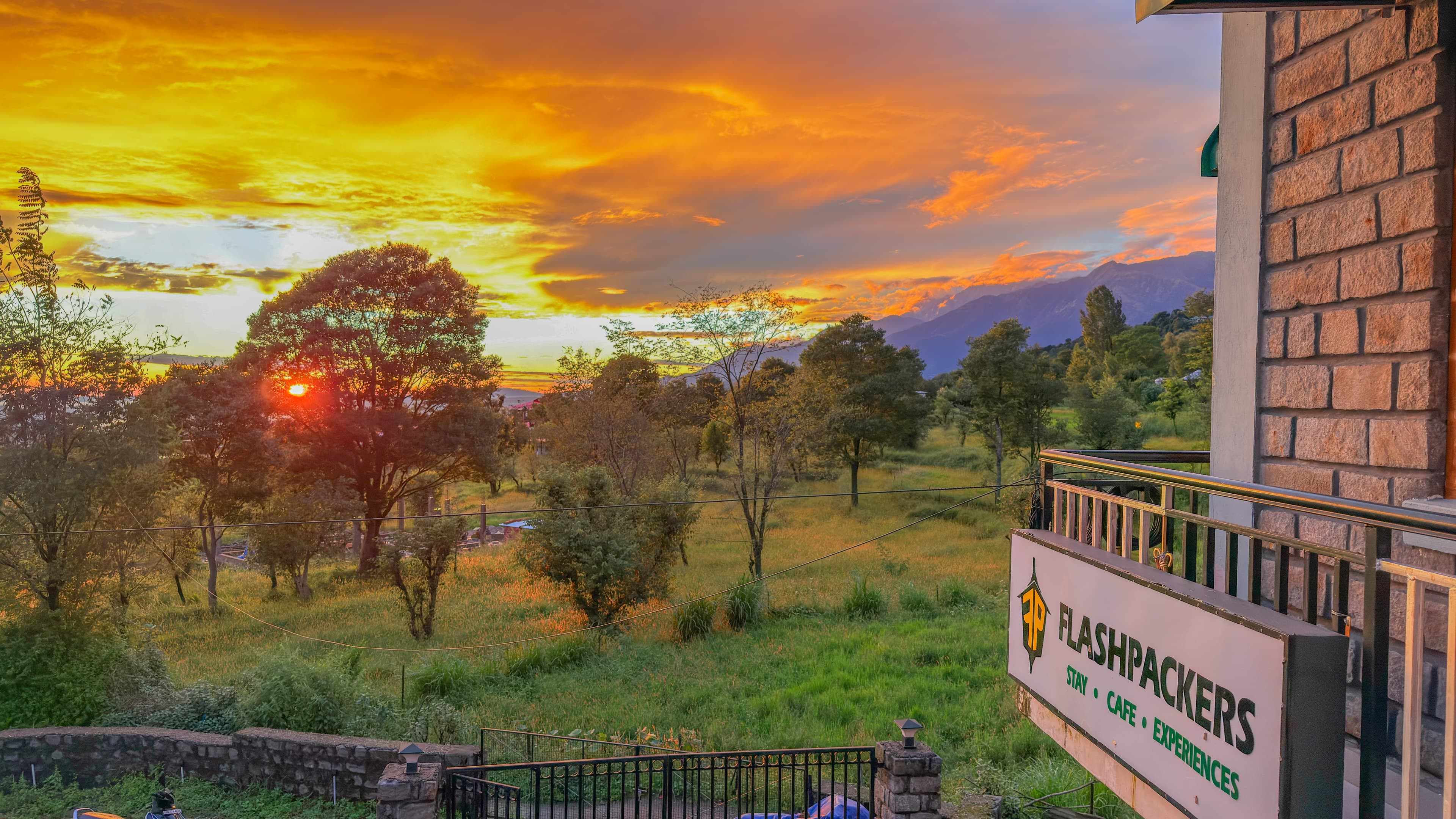 Sunset view from Flashpackers Bir balcony overlooking mountains