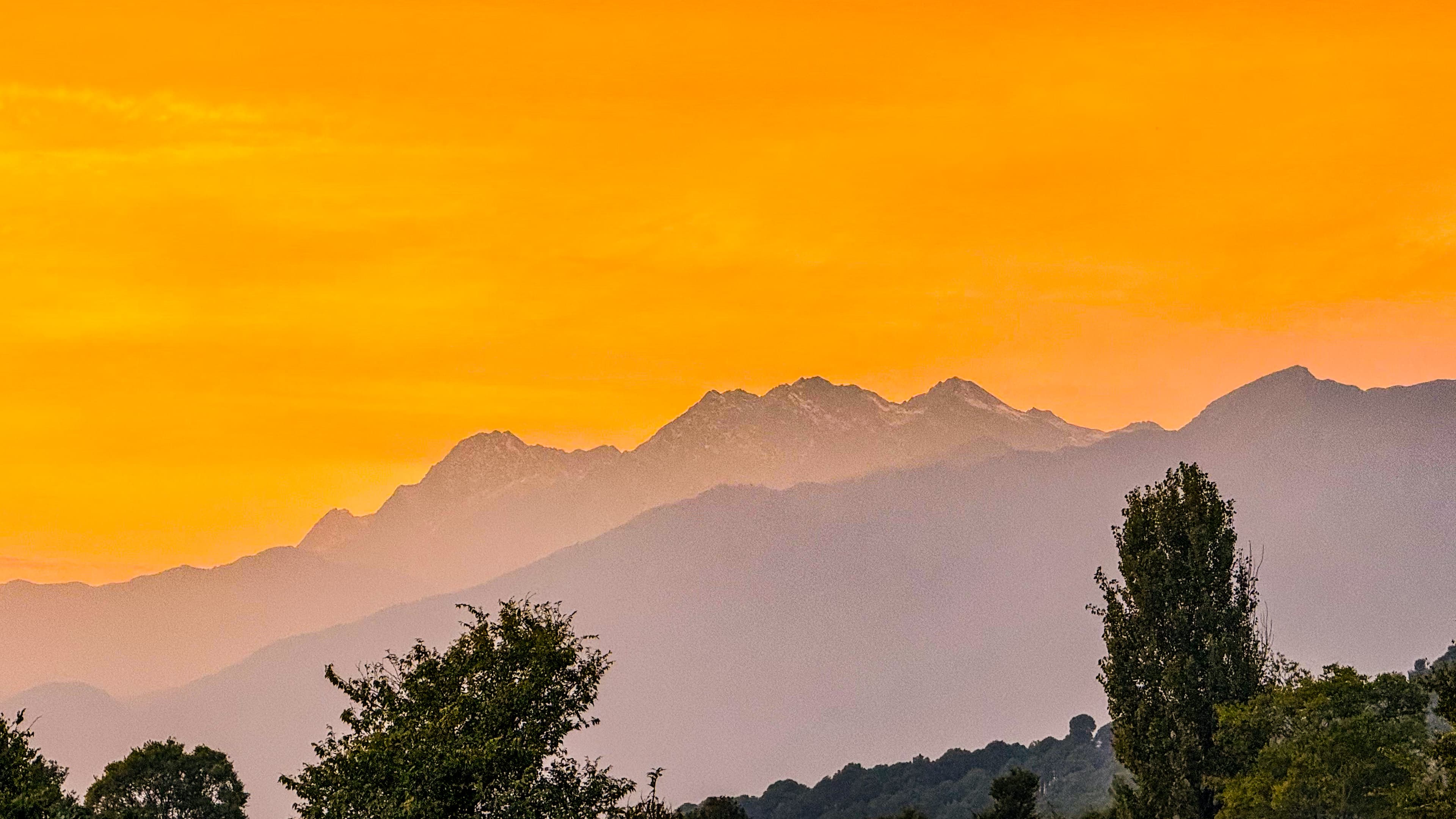 Sunset over layered mountain ranges