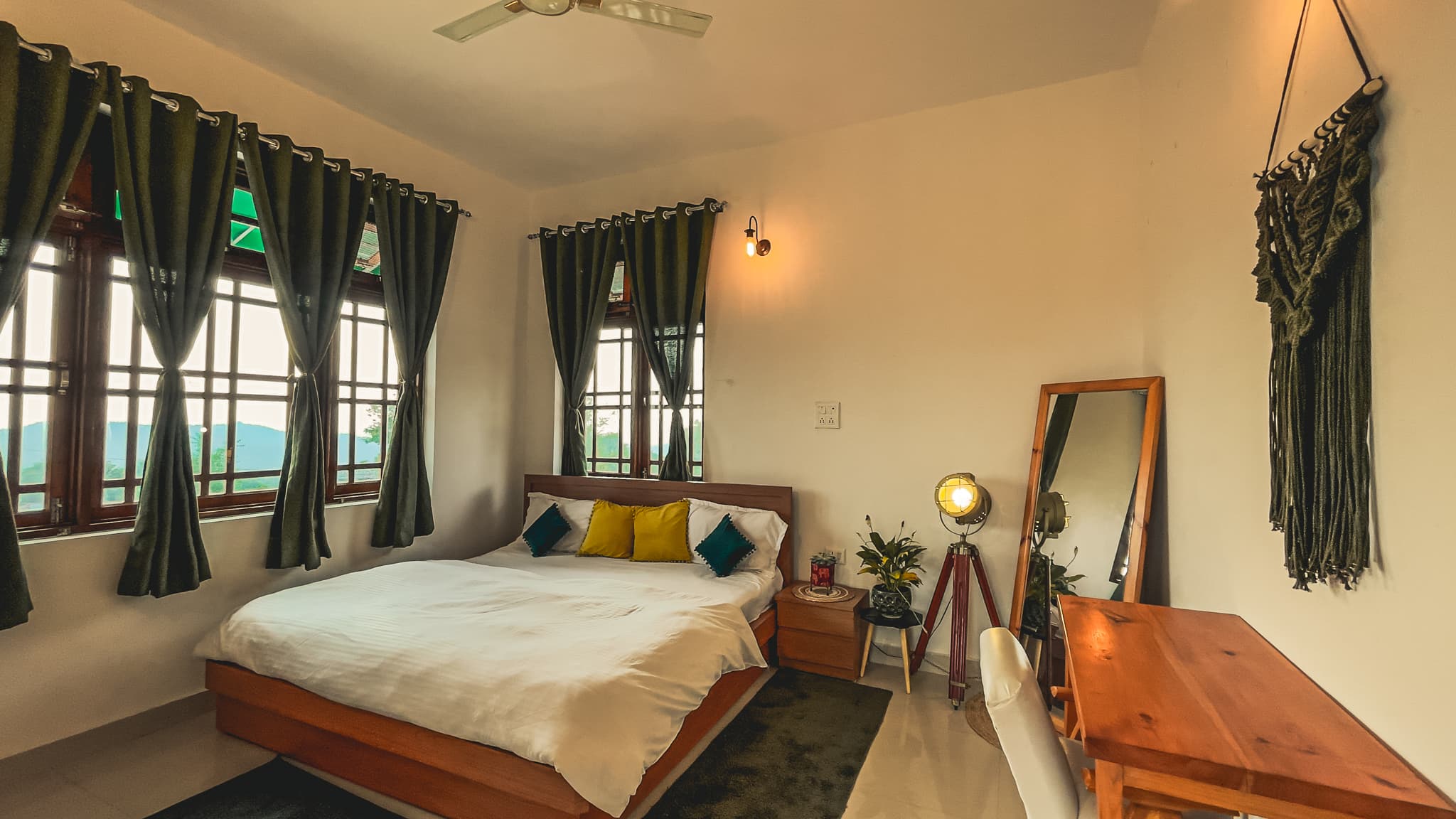 Dramatic orange sunset over mountains with green field